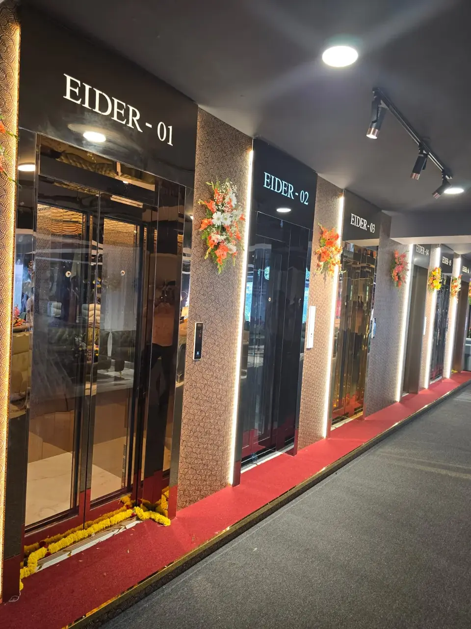 Corridor with two Eider passenger lifts, labelled EIDER-01, decorated for opening