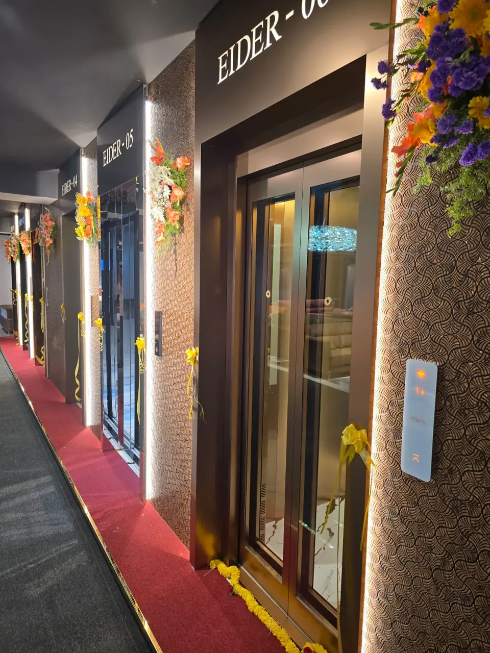 Angled view of an Eider lift entrance along a lit corridor