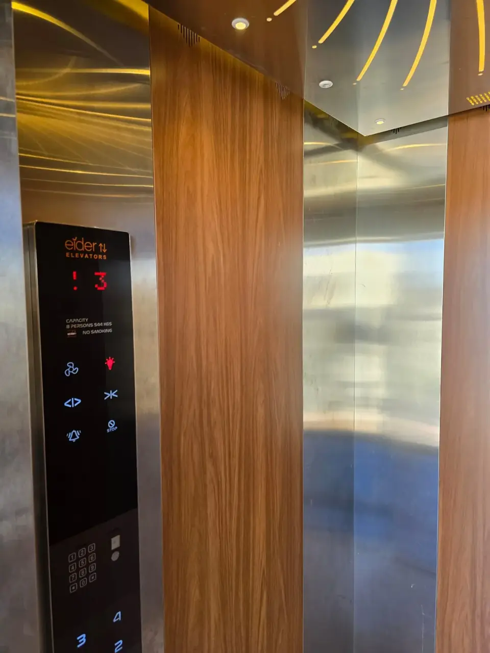 Lift cabin interior with timber wall and Eider control panel